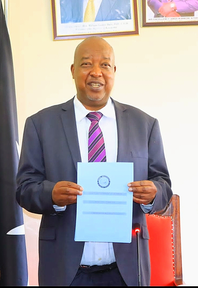 H.E Amos Nyaribo displays a charter he signed to elevate Keroka town into a municipality